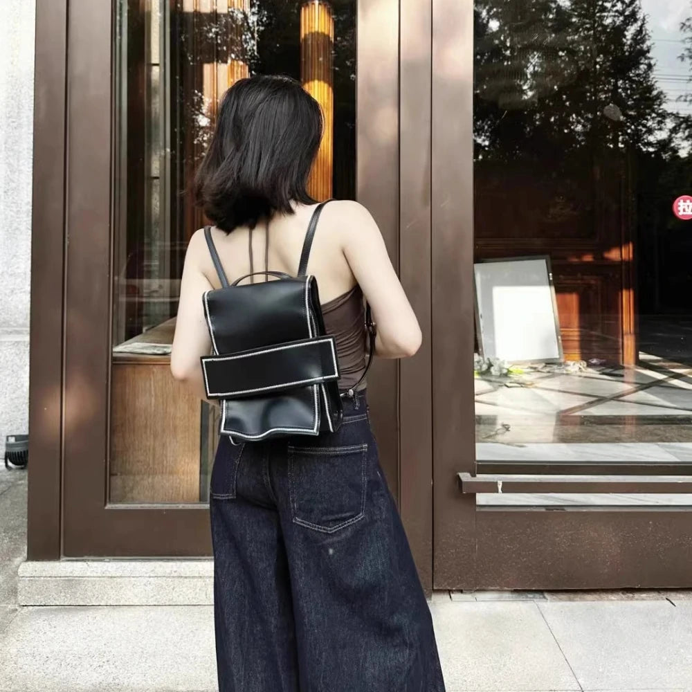 Rear view of a model wearing the Somlord 2-in-1 Convertible Leather Mini Backpack in backpack mode, highlighting the adjustable straps and ergonomic design for comfortable everyday wear.