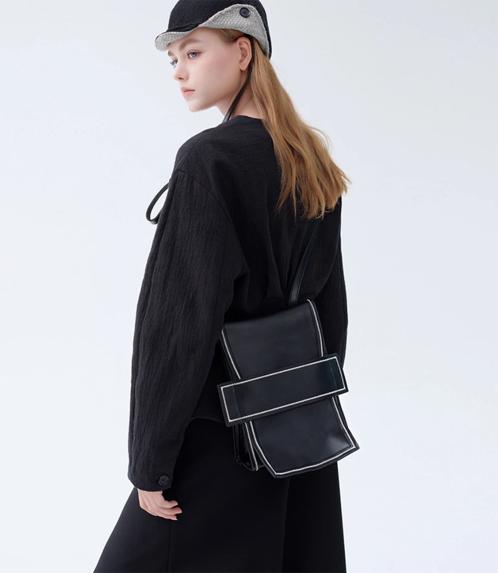 Elegant everyday carry – Convertible Mini Leather Backpack worn as a chic shoulder bag.