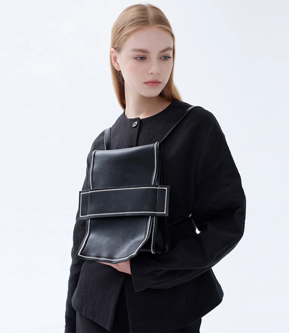 Fashion-forward and functional – Leather Mini Backpack styled as a statement crossbody accessory.
