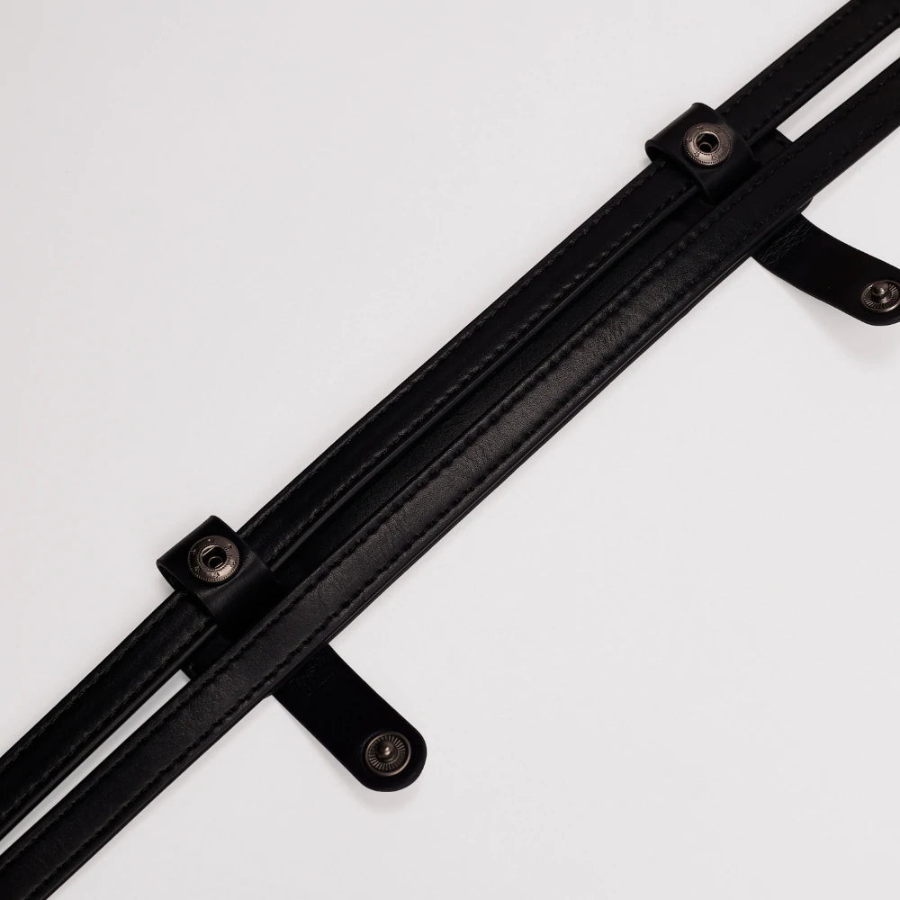 Close-up of the snap button mechanism on the Somlord Anti-Slip Soft Leather Shoulder Pad, ensuring easy attachment and secure fit for various bag types.