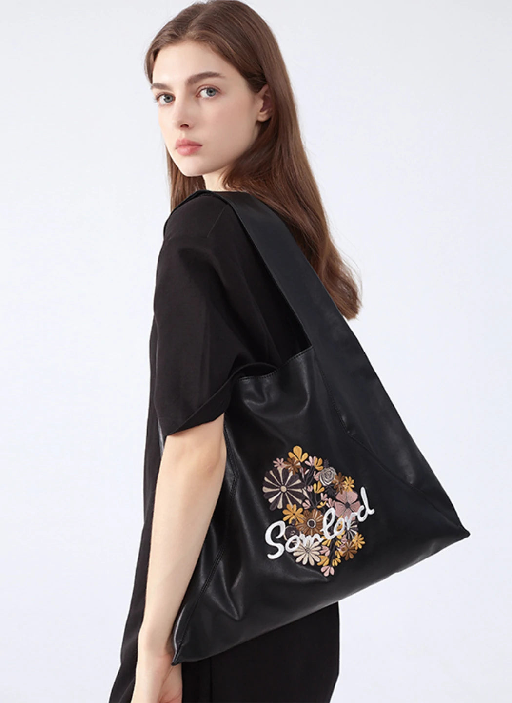 Statement-making Artistic Embroidered Tote Bag – triangle-shaped design, featuring premium soft leather and secure magnetic closure for everyday use.