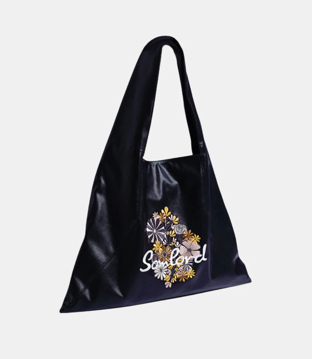 Artistic Embroidered Triangle Soft Leather Tote Bag – black leather tote with intricate floral embroidery, designed for modern elegance.