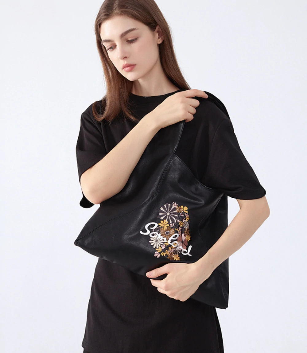 Discover the Artistic Embroidered Triangle Soft Leather Tote Bag – a blend of vintage elegance and modern style. Ideal for daily wear or special occasions, this unique triangle tote offers comfort, durability, and timeless appeal.
