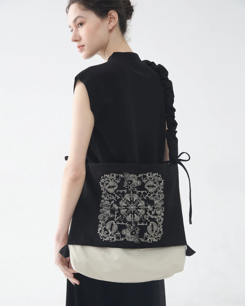 Back view of Somlord Artistic Slouchy Embroidered Crossbody Bag, emphasizing the artistic embroidery design and flexible crossbody strap for versatile wear.