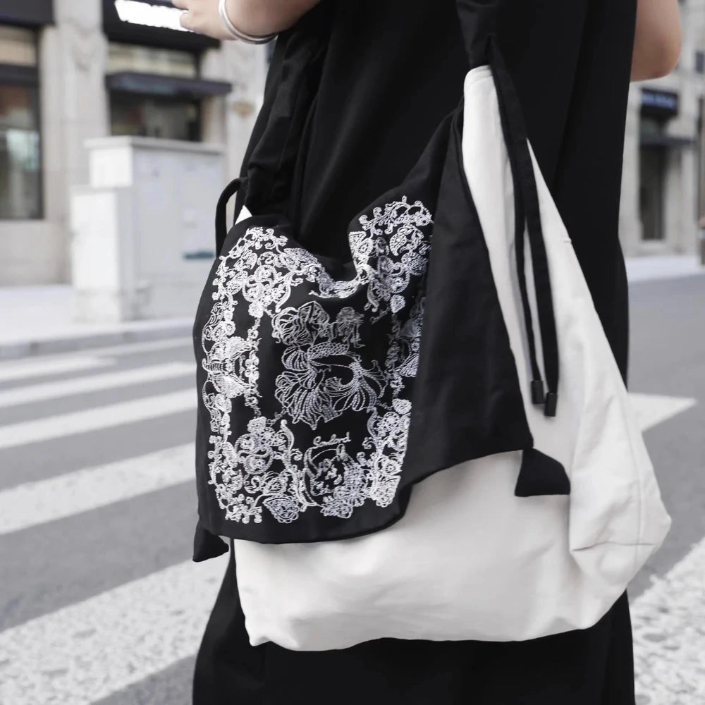 Model walking confidently with Somlord Artistic Slouchy Embroidered Crossbody Bag, showcasing embroidered artistry and a relaxed urban style.