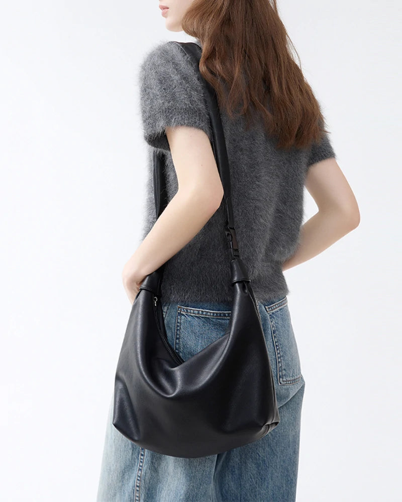 Somlord Slouchy Leather Hobo Bag – Model wearing a minimalist black leather hobo bag, styled for versatile day-to-night looks.