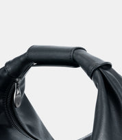 Close-up of reinforced hand-stitched leather handle – adaptable for casual and formal looks, ensuring effortless sophistication.