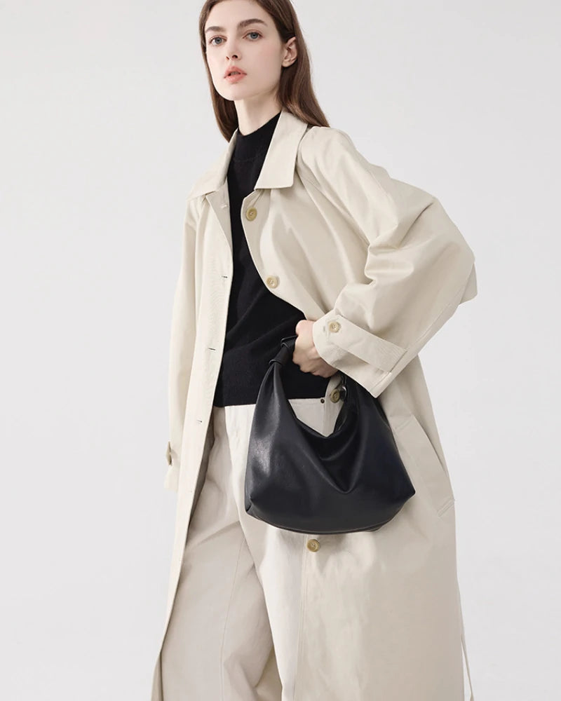 Somlord Retro Leather Hobo Bag – Model styling a black leather hobo bag with trench coat, highlighting modern elegance and urban sophistication.