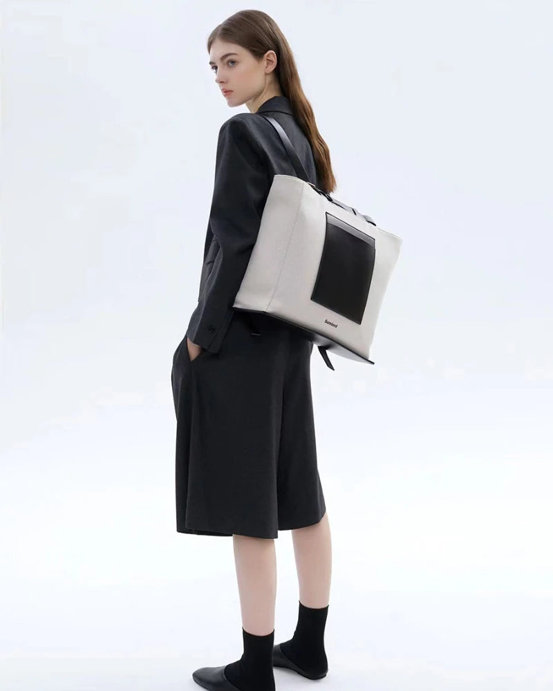 Somlord Urban Hybrid Canvas Structured Tote Backpack – Model wearing a minimalist urban canvas tote, sleek black and white design, ideal for professional and casual use.