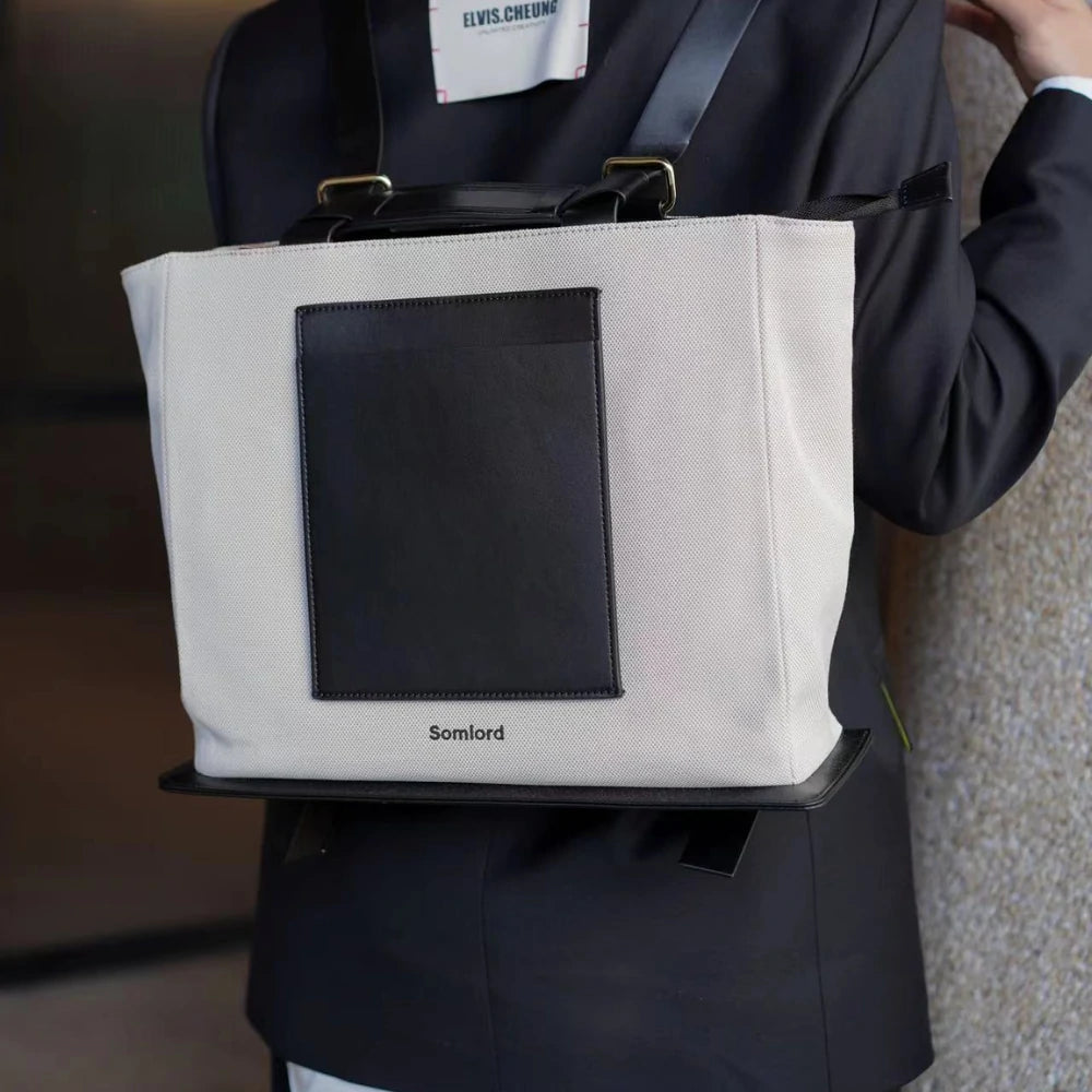 Somlord Structured Canvas Tote Backpack – Close-up detail shot, durable canvas material, black leather accents, ideal for professional and casual settings.