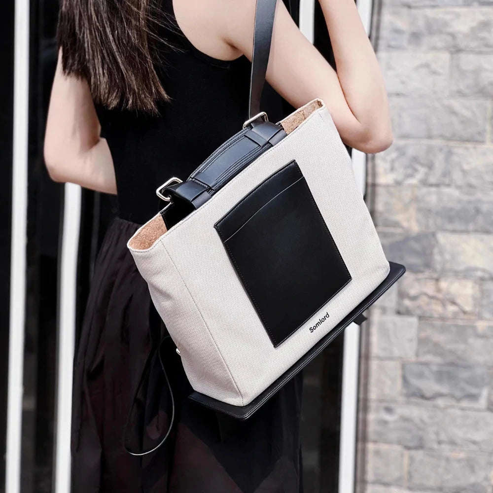 Somlord Urban Canvas Tote Backpack – Model carrying a structured tote backpack, versatile design, crafted for casual outings and professional use.