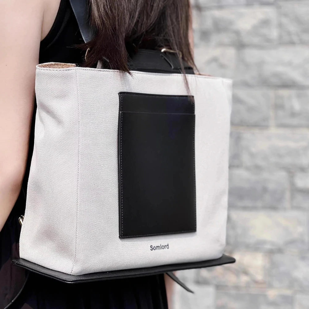 Somlord Canvas Structured Tote Backpack – Close-up shot highlighting premium canvas material and black leather accents, showcasing durability and urban elegance.